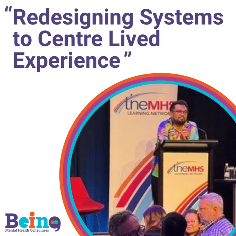Being Mental Health Consumers session graphic: Redesigning Systems to Centre Lived Experience, with a speaker at the TheMHS lectern