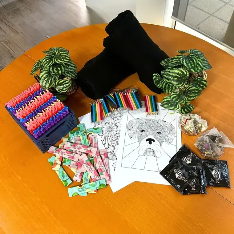Sensory room items including blankets, colouring, fidget toys and tea